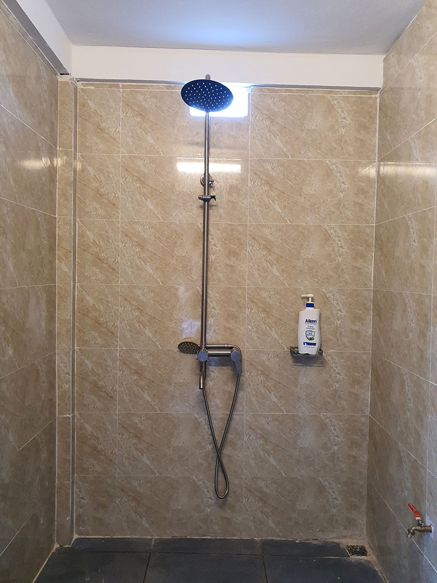 The bathroom has a large shower, hot and healthy water